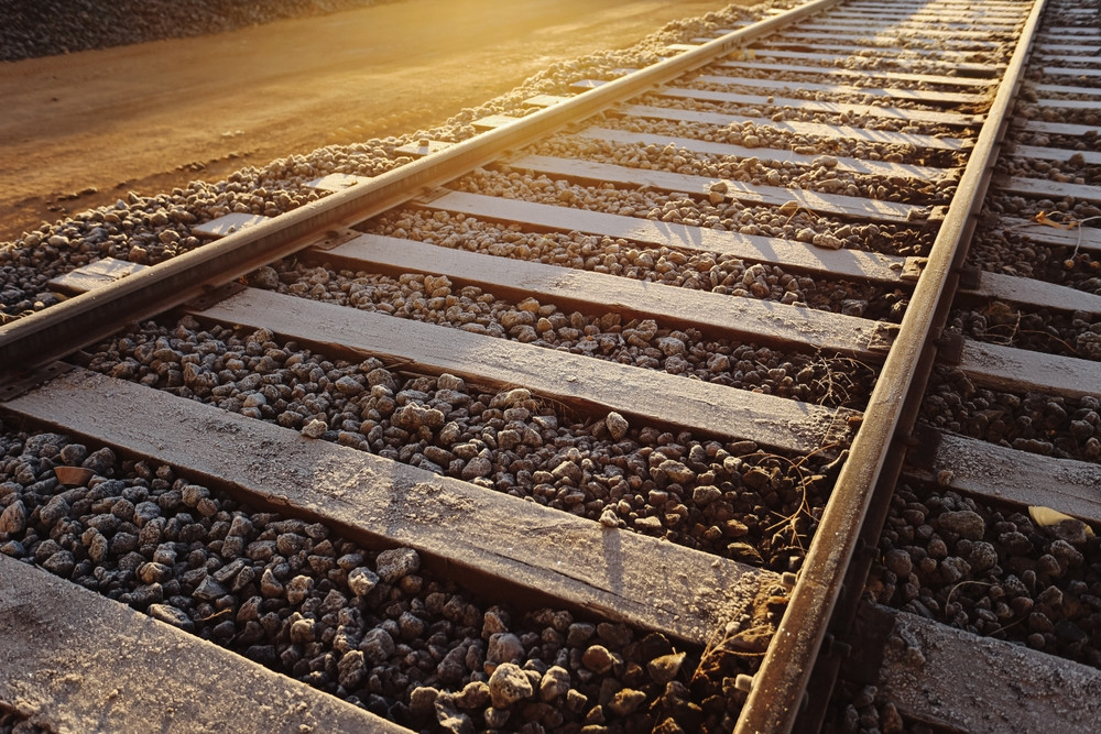 Railroad tracks stretching into the distance at sunset